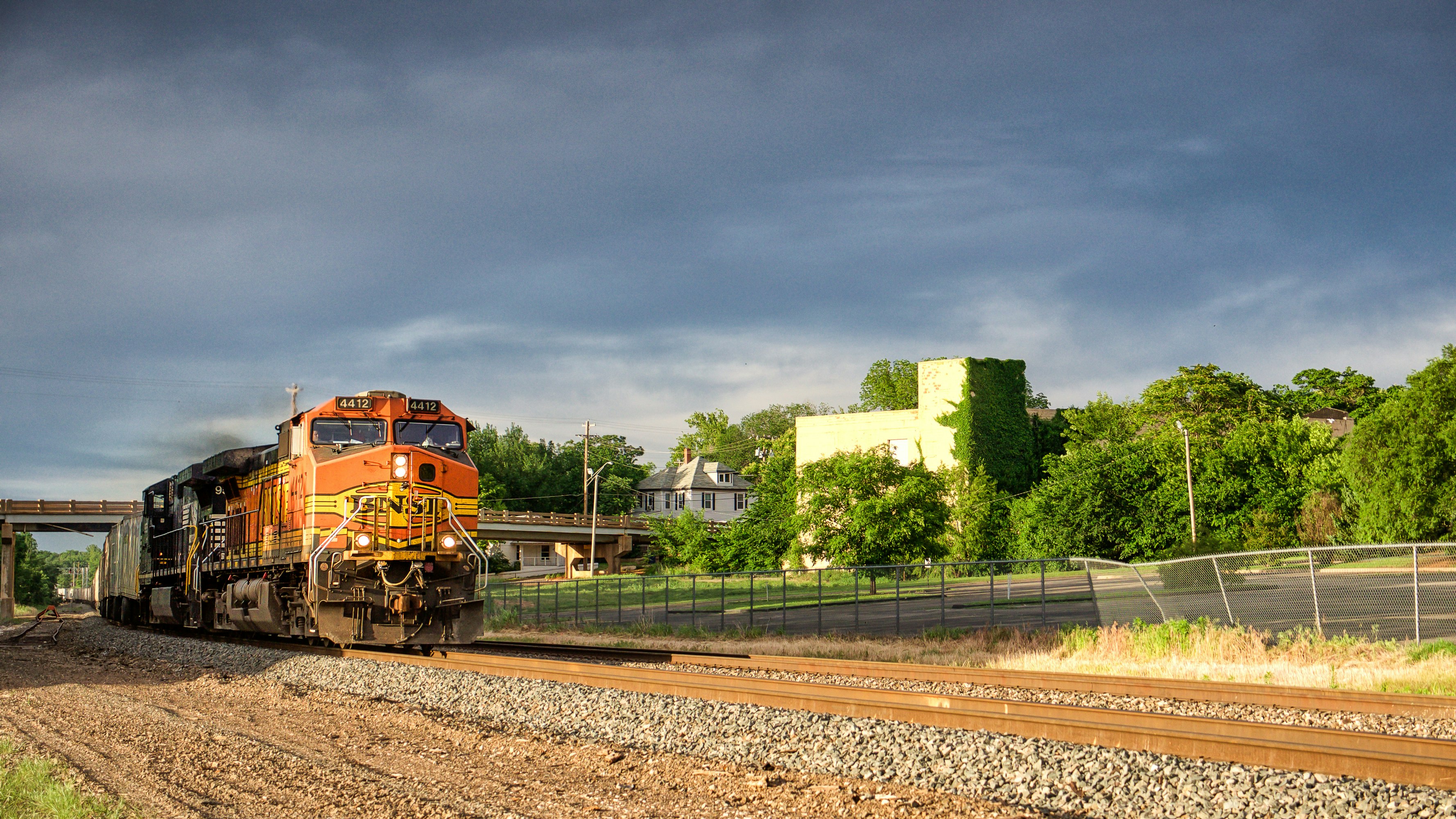 orange train on rail road during daytime